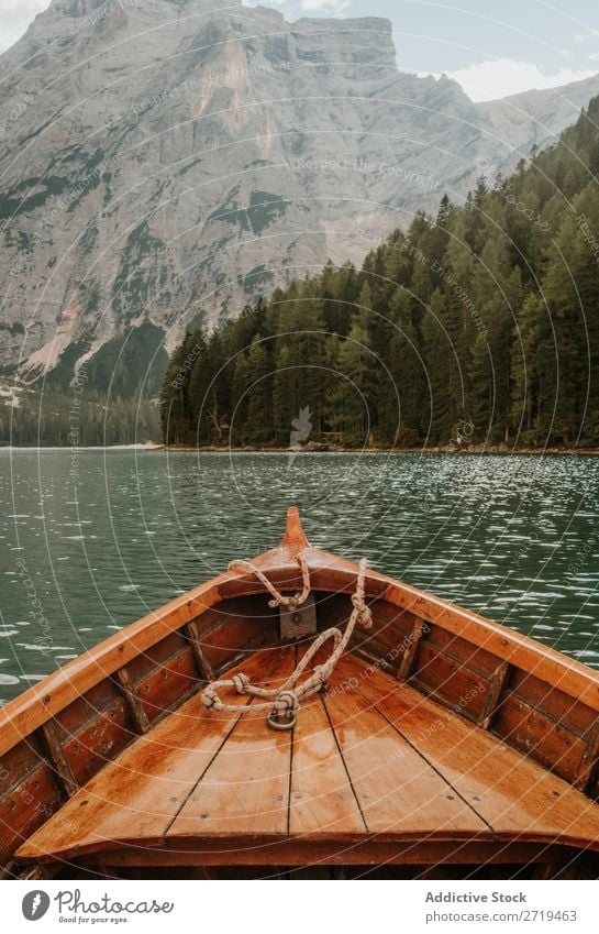 Crop wooden boat on lake Watercraft Lake Mountain Forest Beak Evergreen coniferous Exterior shot Panorama (Format) Landscape scenery tranquil Serene Crops