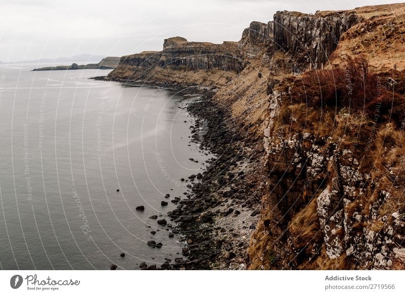 Coastal hills in dry grass Rock Lake Hill Mountain Landscape Nature Water Natural seascape Stone Beautiful Clouds Scotland Grass Vacation & Travel Cliff