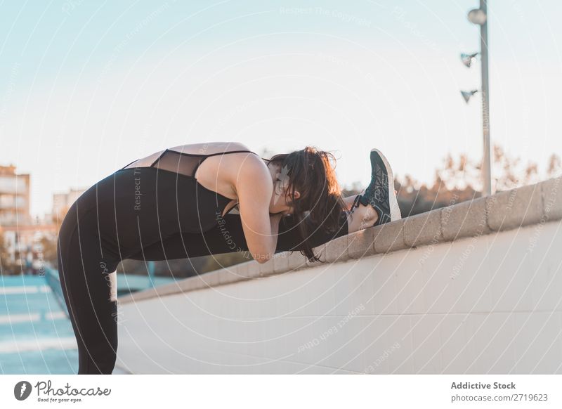 Woman stretching leg at fence Athletic pretty Youth (Young adults) Stretching Legs bending Park City Beautiful Sports Lifestyle Style Attractive pose Healthy