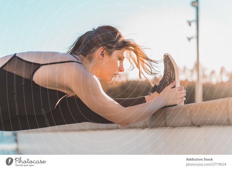 Woman stretching leg at fence Athletic pretty Youth (Young adults) Stretching Legs bending Park City Beautiful Sports Lifestyle Style Attractive pose Healthy