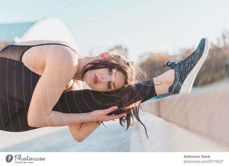 Woman stretching leg at fence Athletic pretty Youth (Young adults) Stretching Legs bending Park City Beautiful Sports Lifestyle Style Attractive pose Healthy