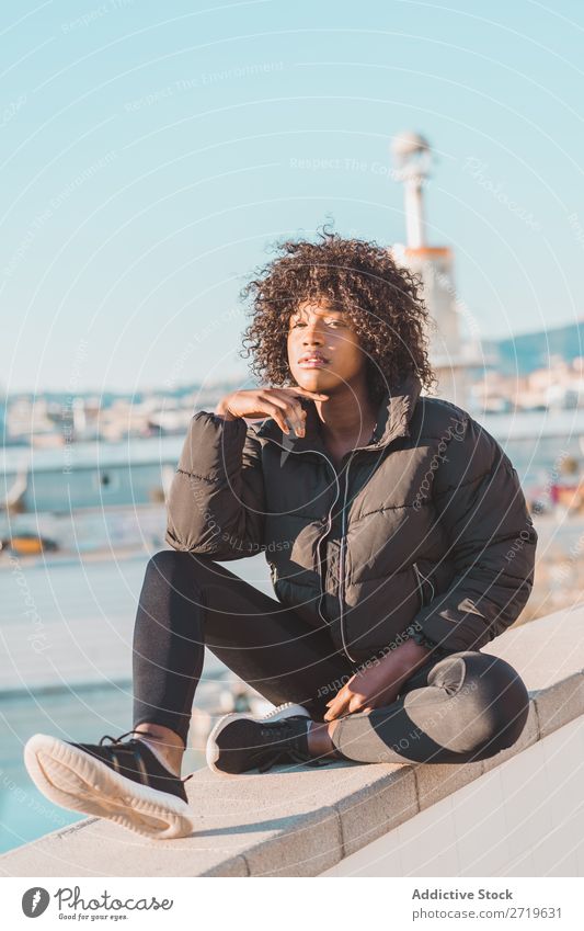 Stylish woman sitting on fence Woman Ethnic pretty Beautiful Youth (Young adults) City Park Sit Fence Style Easygoing Cool (slang) Portrait photograph