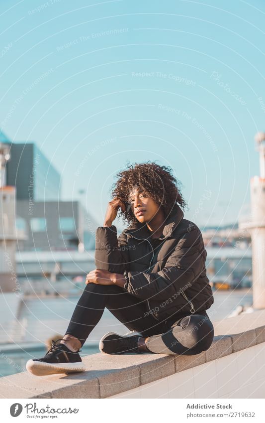 Stylish woman sitting on fence Woman Ethnic pretty Beautiful Youth (Young adults) City Park Sit Fence Style Easygoing Cool (slang) Portrait photograph