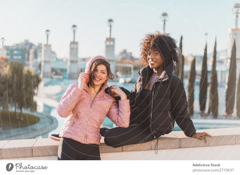 Cheerful women posing at fence Woman pretty Beautiful Youth (Young adults) Pond Park Looking into the camera Cool (slang) City Town Style Portrait photograph