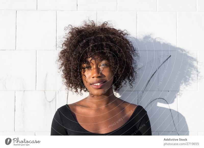 Ethnic woman at white wall Woman pretty Beautiful Youth (Young adults) Portrait photograph Human being Attractive Curly Black Face Nationalities and ethnicity