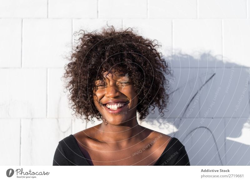 Ethnic woman at white wall Woman pretty Beautiful Youth (Young adults) Portrait photograph Human being Attractive Curly Black Face Nationalities and ethnicity