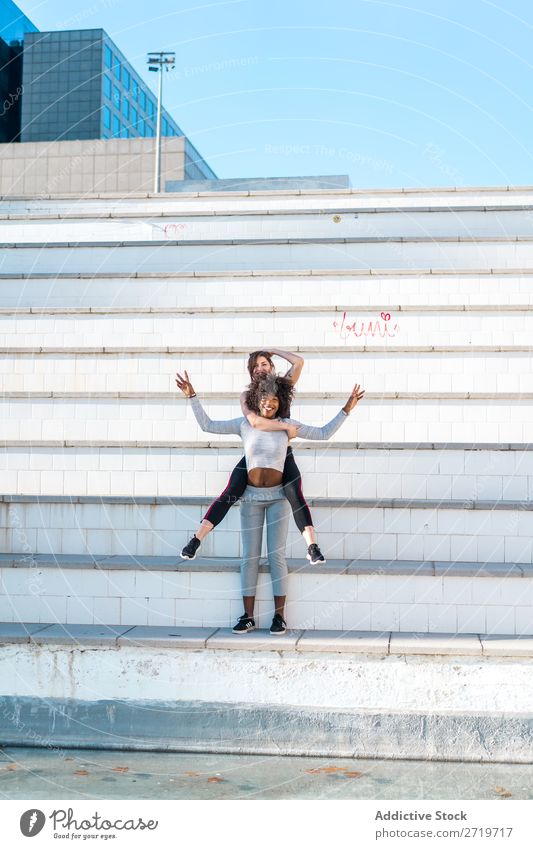 Woman carrying her friend behind her back Athletic Together pretty Youth (Young adults) Cheerful Smiling Steps Jump Stretching Beautiful Sports multiethnic