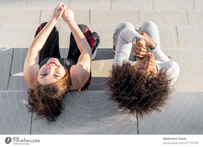 Happy friends sitting on steps Woman pretty Beautiful Youth (Young adults) Sit Steps Looking into the camera Cool (slang) City Town Style Portrait photograph