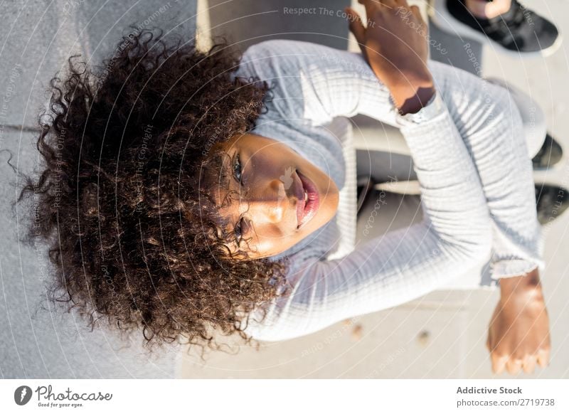 Pretty ethnic woman on steps Woman Ethnic pretty Beautiful Youth (Young adults) Portrait photograph Smiling Cheerful delighted Human being Attractive Curly