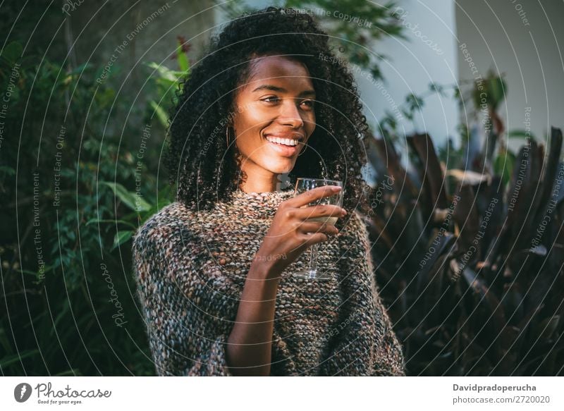 Woman in a countryside house garden drinking wine Ethnic 1 black woman Home Attractive Adults Rural Beautiful Glass Wine Winter Curly Portrait photograph pretty