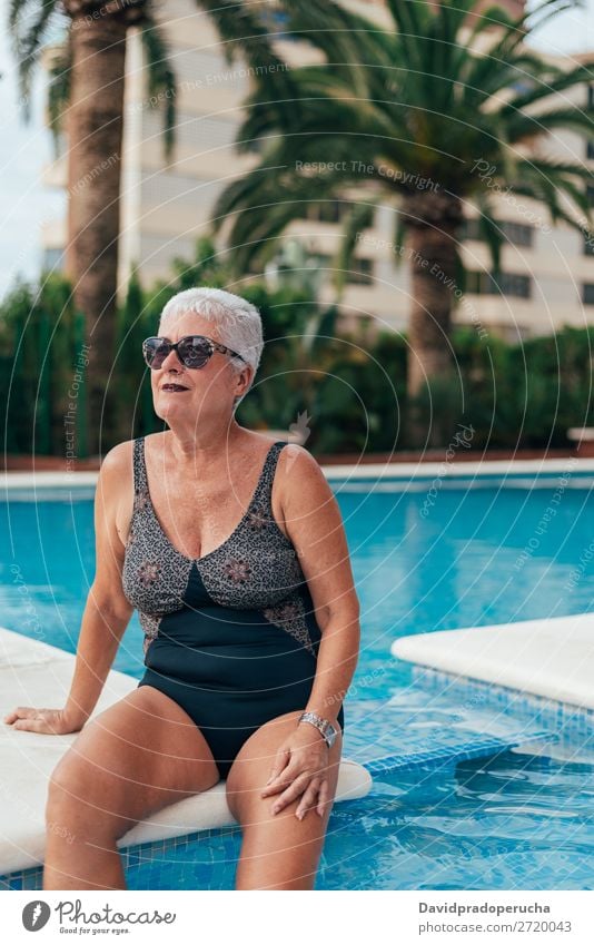 Senior old woman grey hair sitting by the swimming pool Woman Vacation & Travel Old Swimming pool Senior citizen Leisure and hobbies Wellness Caucasian Natural