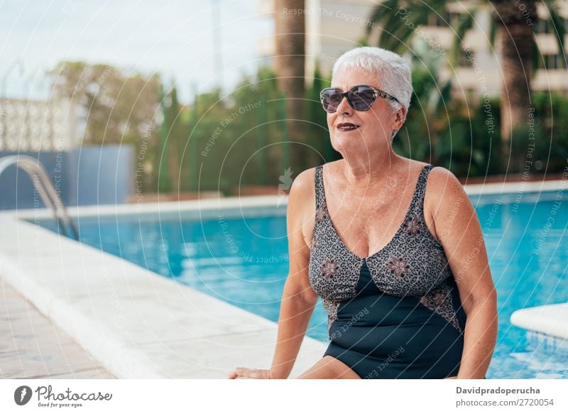 Senior old woman grey hair sitting by the swimming pool Woman Vacation & Travel Old Swimming pool Senior citizen Leisure and hobbies Wellness Caucasian Natural