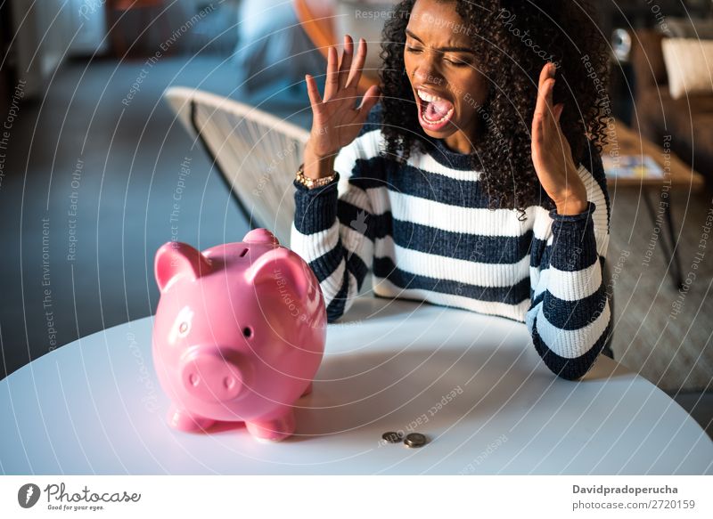 Black unhappy woman angry at piggy bank Woman Money box savings Crisis Sadness Anger Stress Emotions annoyed Scream trouble Expression frustrated Problem