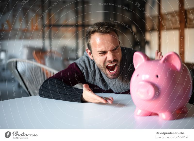 Unhappy man angry at his piggy bank Man Money box savings Crisis Sadness Anger Stress Emotions annoyed Scream trouble Expression frustrated Problem shouting