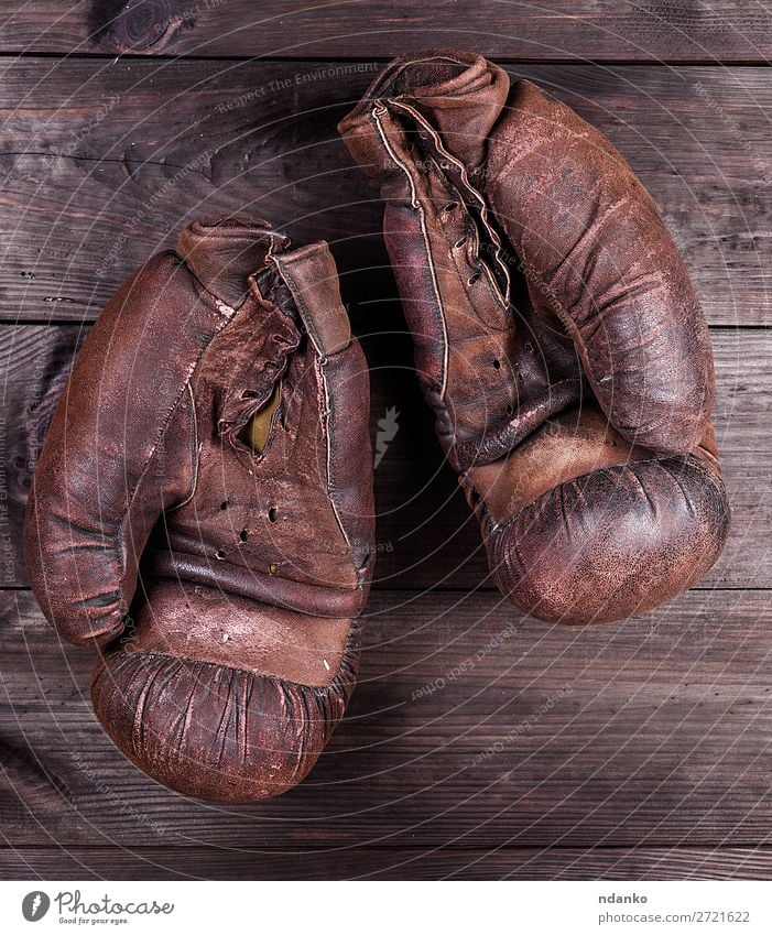 very old brown boxing gloves Sports Leather Gloves Wood Old Fitness Retro Brown Black Protection Competition Action Ancient Antique background boxer Boxing