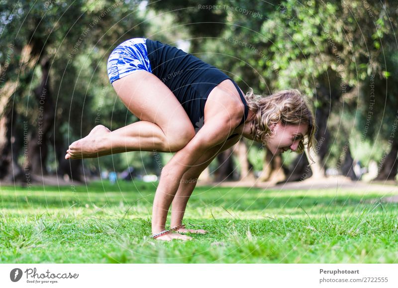 Young woman doing bakasana exercise crane pose yoga Lifestyle Beautiful Body Relaxation Meditation Summer Sports Yoga Human being Woman Adults Nature Grass Park