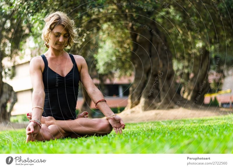 Woman Meditating And Practicing Yoga, Padmasana. Lifestyle Beautiful Body Wellness Harmonious Relaxation Meditation Adults Nature Park Fitness Sit Thin Action