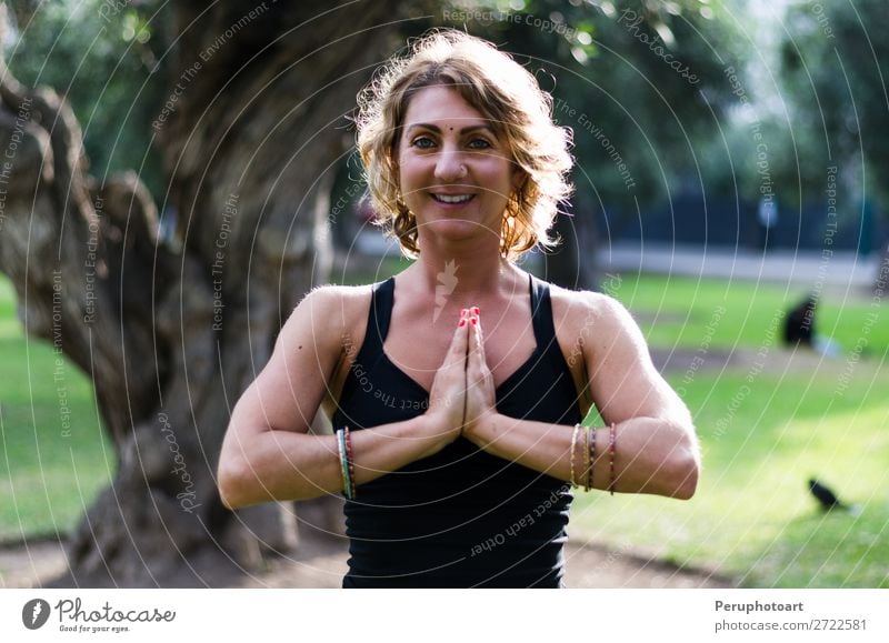 Young woman meditates in yoga asana Padmasana - Lotus pose Lifestyle Wellness Relaxation Meditation Yoga Human being Woman Adults Nature Autumn Leaf Park Wood