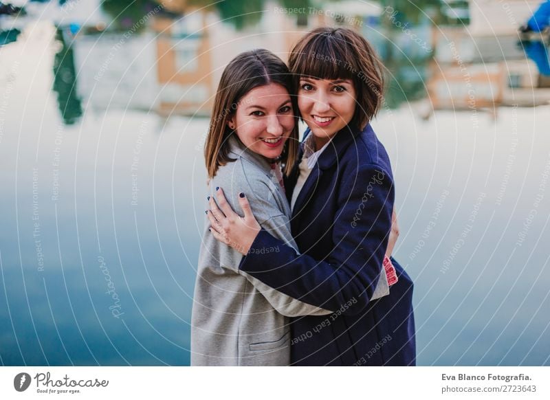 Two happy friends or sisters hugging on the street. Lifestyle Joy Happy Sun Meeting To talk Homosexual Woman Adults Family & Relations Friendship Group Street