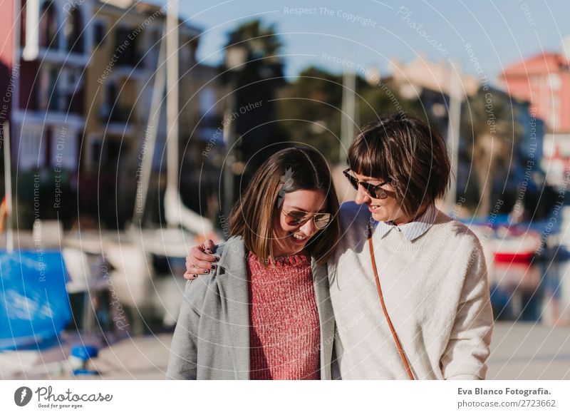 Two happy friends walking by the street Lifestyle Joy Happy Sun Meeting To talk Woman Adults Family & Relations Friendship Group Street Watercraft Smiling