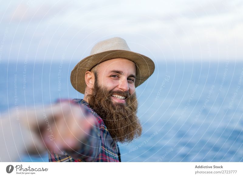 Man holding hands at seaside Tourist Nature bearded Hat Love follow me Gesture Ocean Vacation & Travel Adventure Azores Landscape Hiking Exterior shot