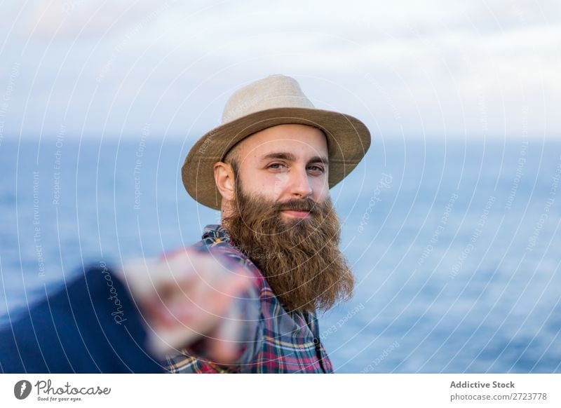 Man holding hands at seaside Tourist Nature bearded Hat Love follow me Gesture Ocean Vacation & Travel Adventure Azores Landscape Hiking Exterior shot