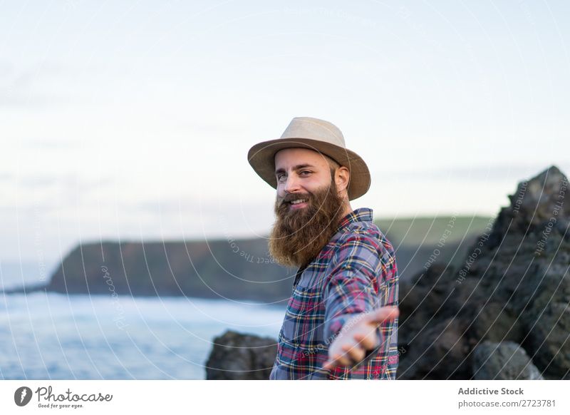 Man holding hands at seaside Tourist Nature bearded Hat Love follow me Gesture Ocean Vacation & Travel Adventure Azores Landscape Hiking Exterior shot