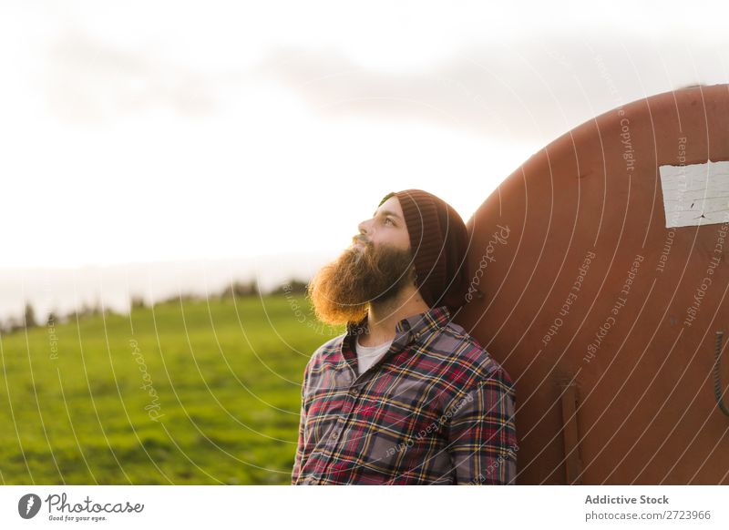 Thoughtful man leaning on barrel Tourist Field Green Landscape Nature Sky Summer bearded Lean Keg Rust Old Looking away Considerate Vacation & Travel Tourism