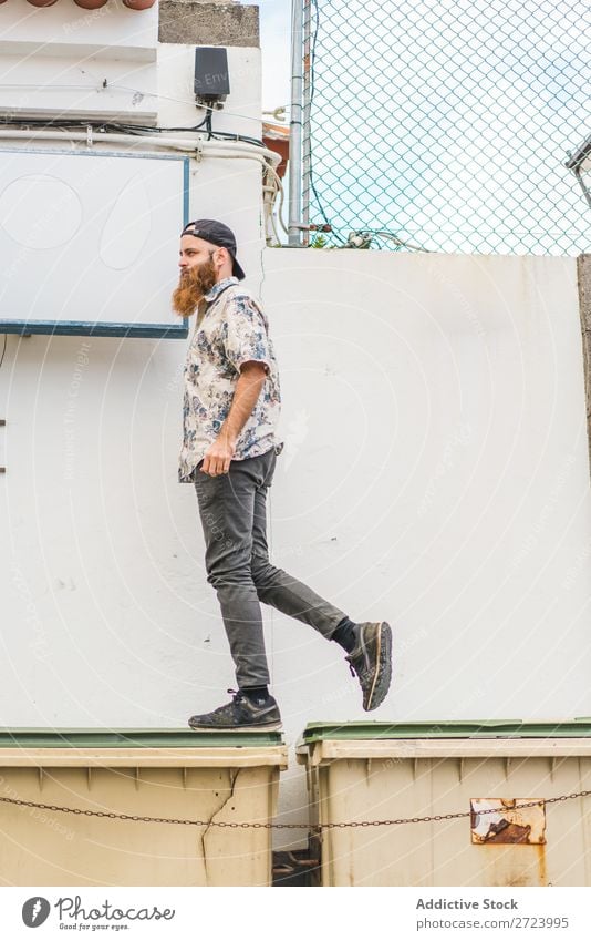 Man walking on dumpsters City Street Walking bearded Trash container Container Lifestyle Youth (Young adults) Posture stepping Town Human being Guy Cool (slang)