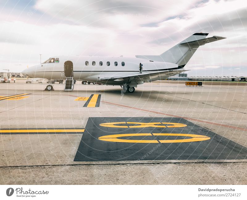 Private luxury jet at the airport terminal aerospace Air Aircraft Airfield Aviation Passenger plane Airplane Airport airstrip Business business class Clouds