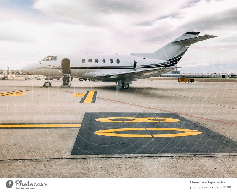 Private luxury jet at the airport terminal Jet Luxury Aviation business class Exclusive Airport Aircraft Airplane Clouds Business Transport Sky Story Runway