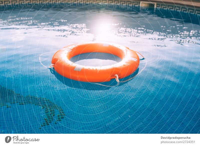 Lifesaver in the swimming pool lifesaver Swimming pool Lifebuoy Safety safe Float in the water Sunlight Help aid Buoy SOS Summer Emergency Safety (feeling of)