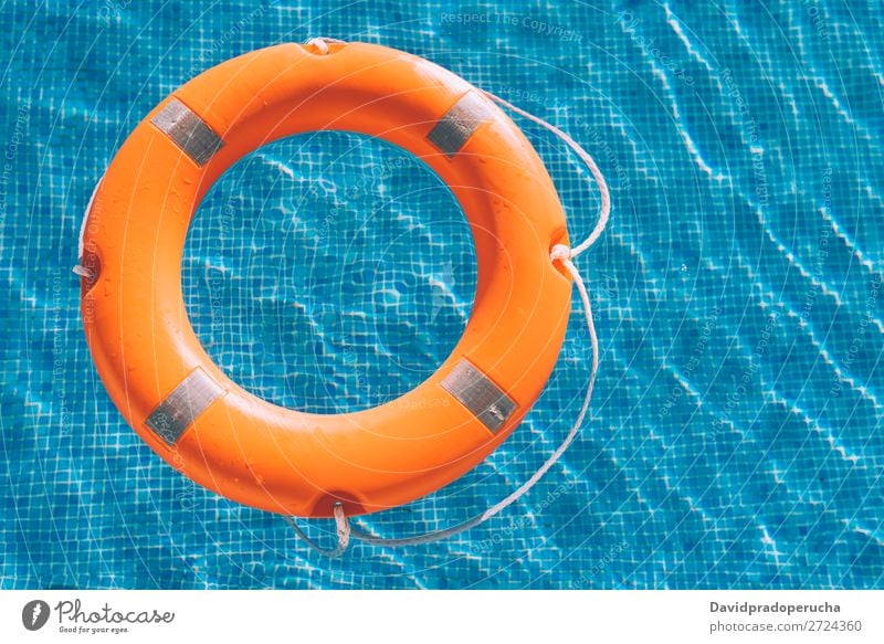 Lifesaver in the swimming pool lifesaver Swimming pool Lifebuoy Safety safe Float in the water Sunlight Help aid Buoy SOS Summer Emergency Safety (feeling of)