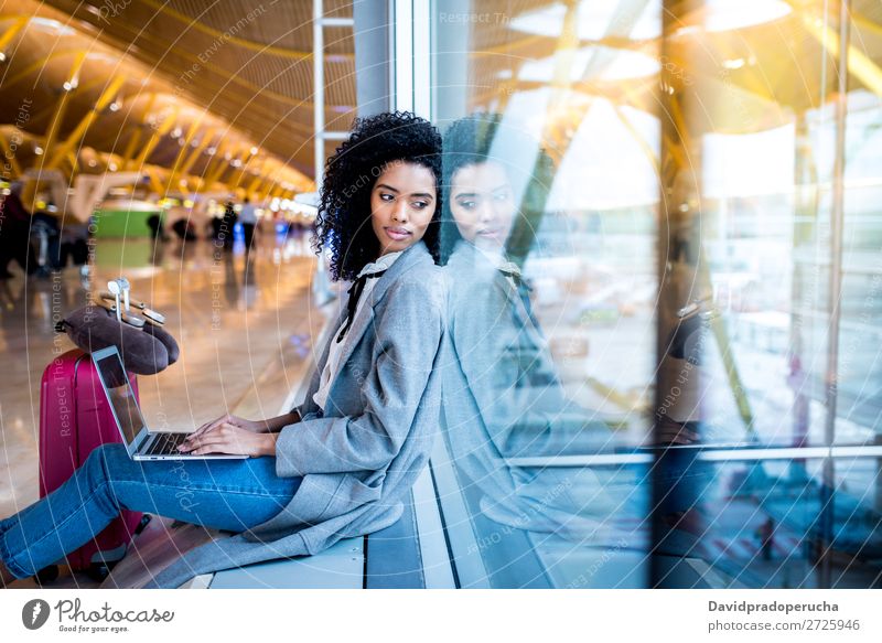 black woman working with laptop at the airport waiting at the window Airport Youth (Young adults) Smiling Wait Black Woman Story Sun Sunrise Window Sunlight