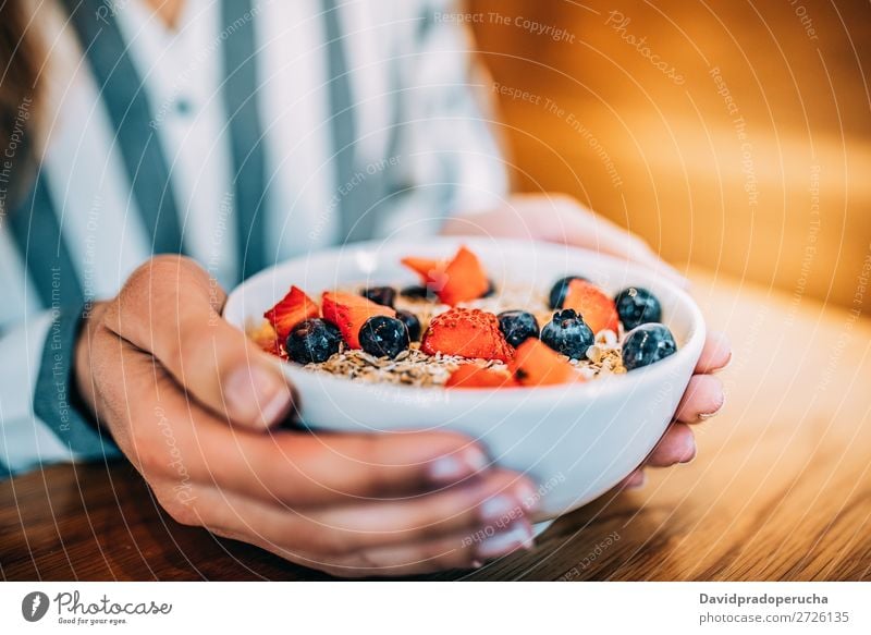 Crop woman close up eating oat and fruits bowl for breakfast Bowl Breakfast Woman Cereal porridge Hand Crops Anonymous Unrecognizable Strawberry Blueberry Oats