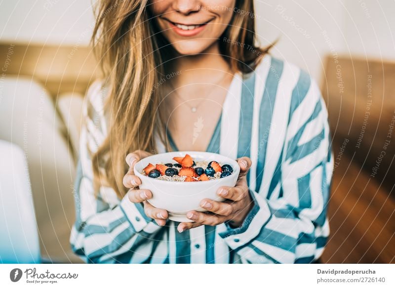 Crop woman close up eating oat and fruits bowl for breakfast Bowl Breakfast Woman Cereal porridge Hand Crops Anonymous Unrecognizable Strawberry Blueberry Oats