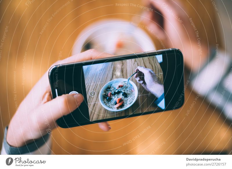 Woman taking photo of a bowl breakfast oats and fruit Photography Shot Mobile PDA Telephone Illustration Take Bowl Strawberry Breakfast Cereal porridge