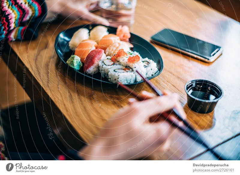 Crop woman eating sushi Sushi Woman Hand Food soy maki california roll Chopstick Roll Crops Unrecognizable Anonymous Close-up Portrait photograph Salmon