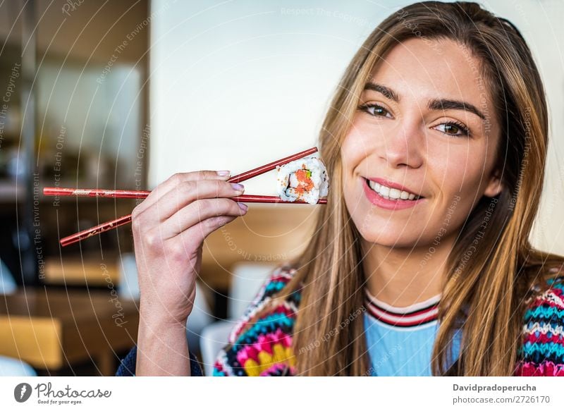 Woman eating sushi Japanese Attractive Beautiful Beauty Photography Blonde california roll Caucasian Chopstick Close-up Delicious Diet Dinner To feed Eating