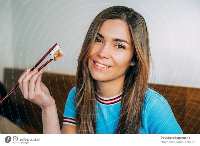 Crop woman eating sushi Sushi Woman Smiling Hand Food soy maki california roll Chopstick Roll Crops Unrecognizable Anonymous Close-up Portrait photograph Salmon