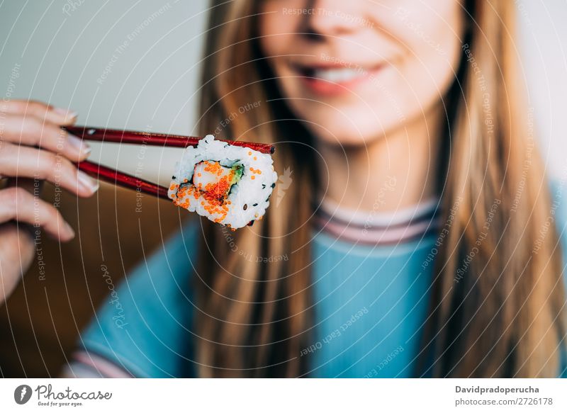 Crop woman eating sushi Sushi Woman Smiling Hand Food soy maki california roll Chopstick Roll Crops Unrecognizable Anonymous Close-up Portrait photograph Salmon