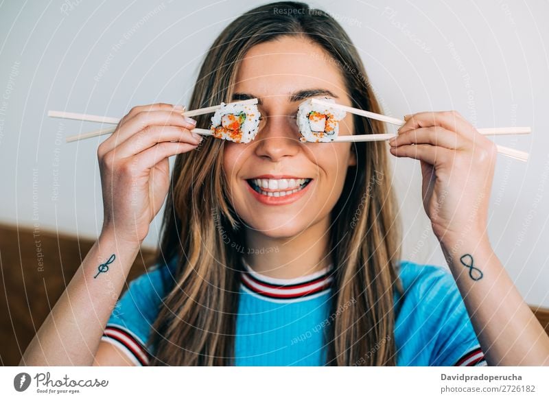 woman covering her eyes with pieces of sushi Sushi Woman Smiling Hand Food soy maki california roll Chopstick Roll Crops Unrecognizable Anonymous Close-up