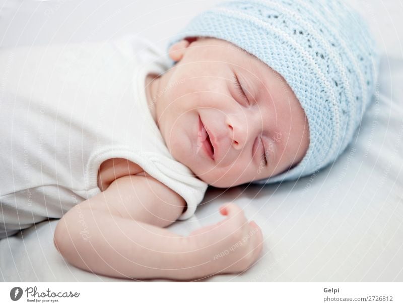 Beautiful baby with blue cap sleeping peacefully Lifestyle Joy Happy Skin Face Child Human being Baby Toddler Boy (child) Man Adults Infancy Warmth Hat Smiling