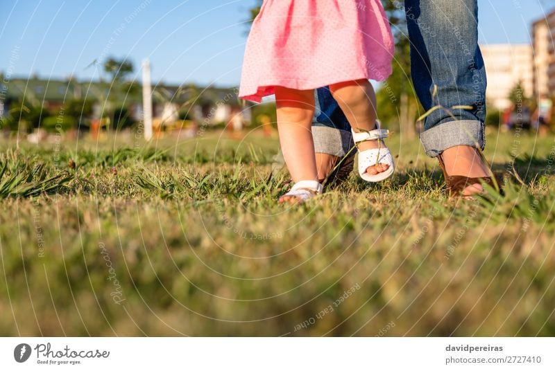 Baby girl learning to walk over a grass park Lifestyle Joy Happy Leisure and hobbies Summer Garden Human being Toddler Woman Adults Mother Family & Relations