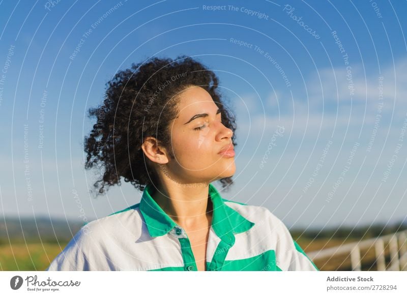 Curly woman posing on nature in sunlight Woman Summer To enjoy Posture human face Landscape Nature Colour Portrait photograph tranquil Exterior shot Countries