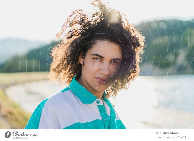 Curly woman posing on nature in sunlight Woman Summer To enjoy Posture human face Landscape Nature Colour Portrait photograph tranquil Exterior shot Countries