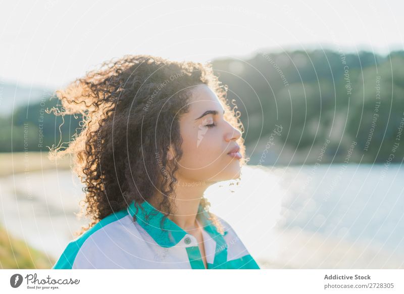 Dreaming woman in sunlight on nature Woman Summer To enjoy Posture Landscape Freedom Nature eyes closed Curly Easygoing Colour Beautiful Exterior shot