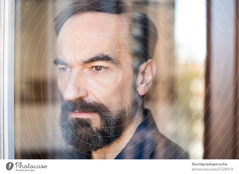 Portrait of a mature man posing thoughtful throughout the window Portrait photograph Man Mature Old Seat Beard Unshaven Considerate Stand Background picture