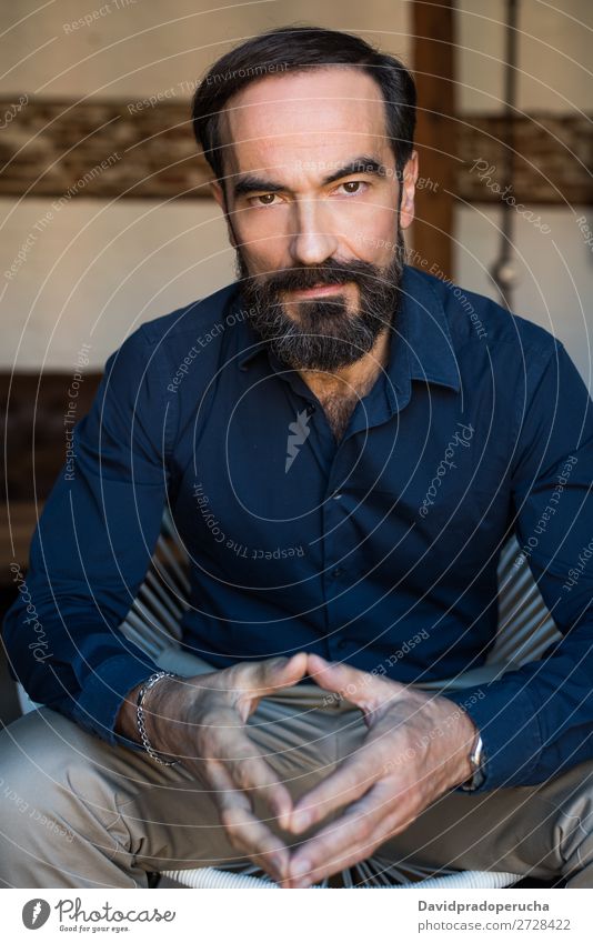 Portrait of a mature man sitting on the chair posing thoughtful Portrait photograph Chair Man Mature Old Seat Beard Unshaven Conceptual design Well Dressed