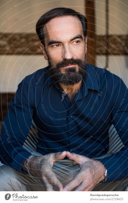 Portrait of a mature man sitting on the chair posing thoughtful Portrait photograph Chair Man Mature Old Seat Beard Unshaven Conceptual design Well Dressed